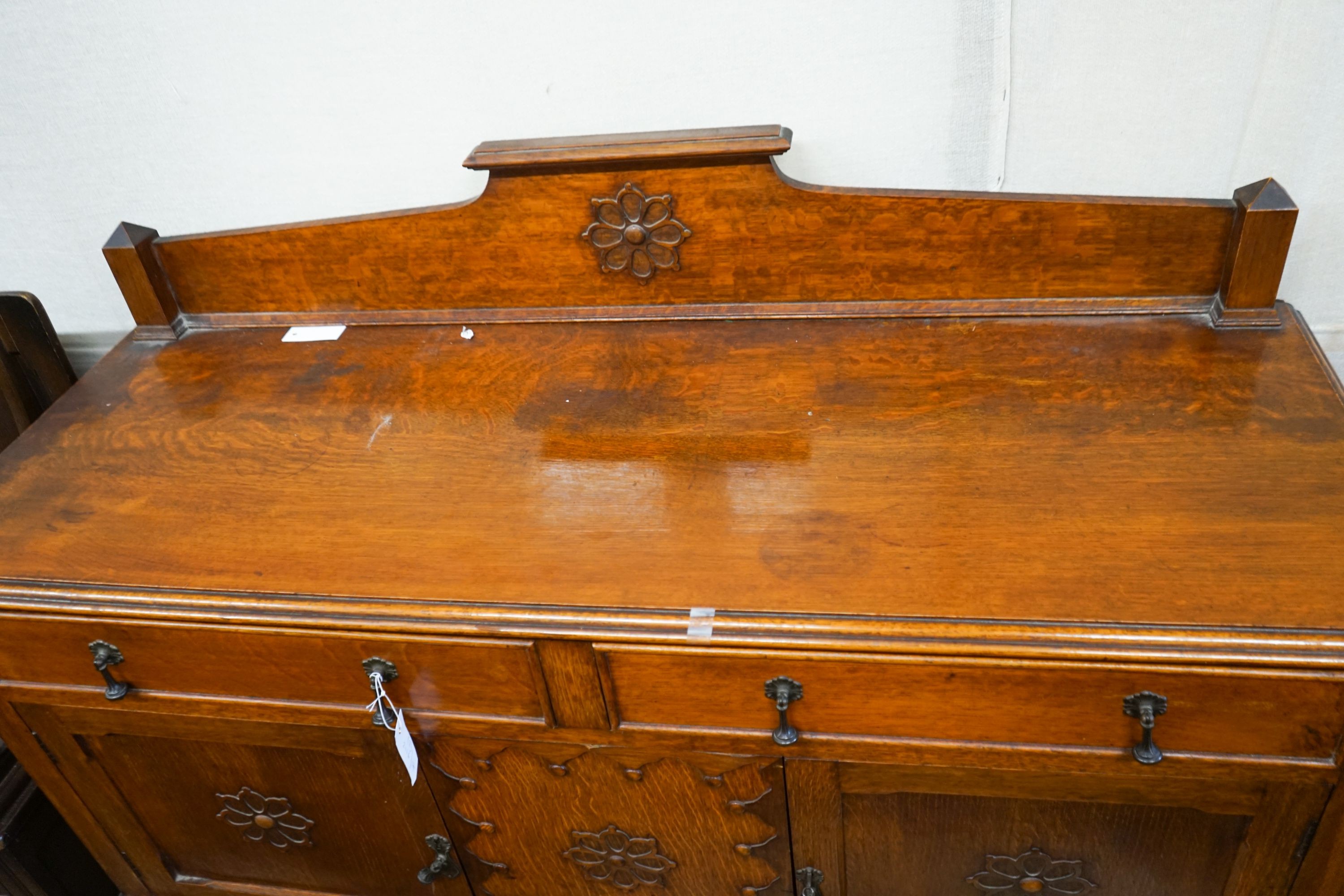 An 18th century style oak monks bench together with a 1920's oak sideboard